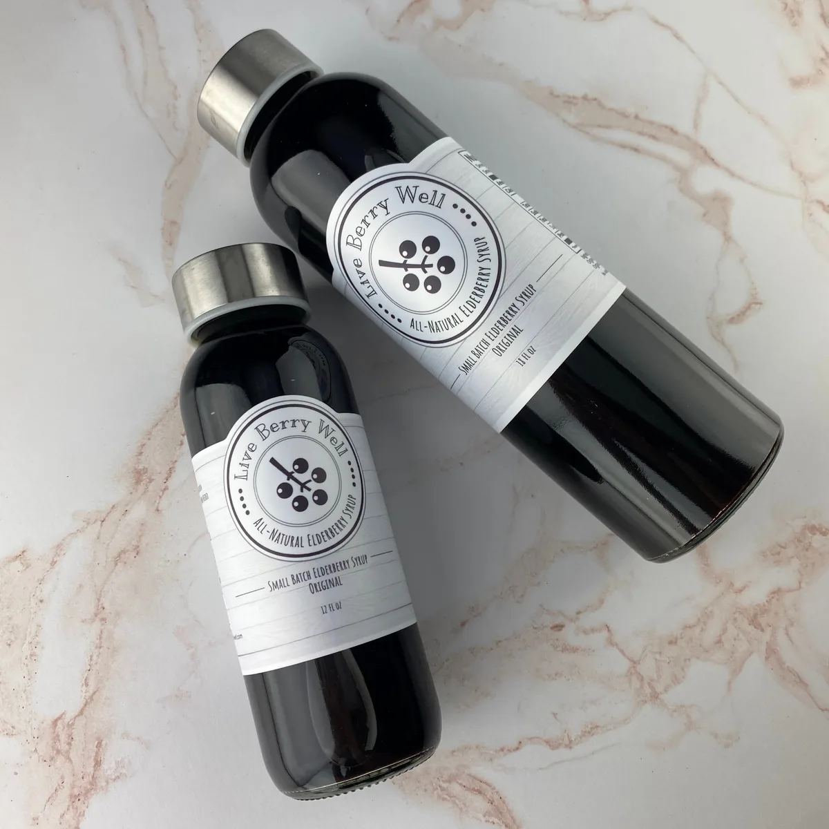 Elderberry syrup bottles on marble