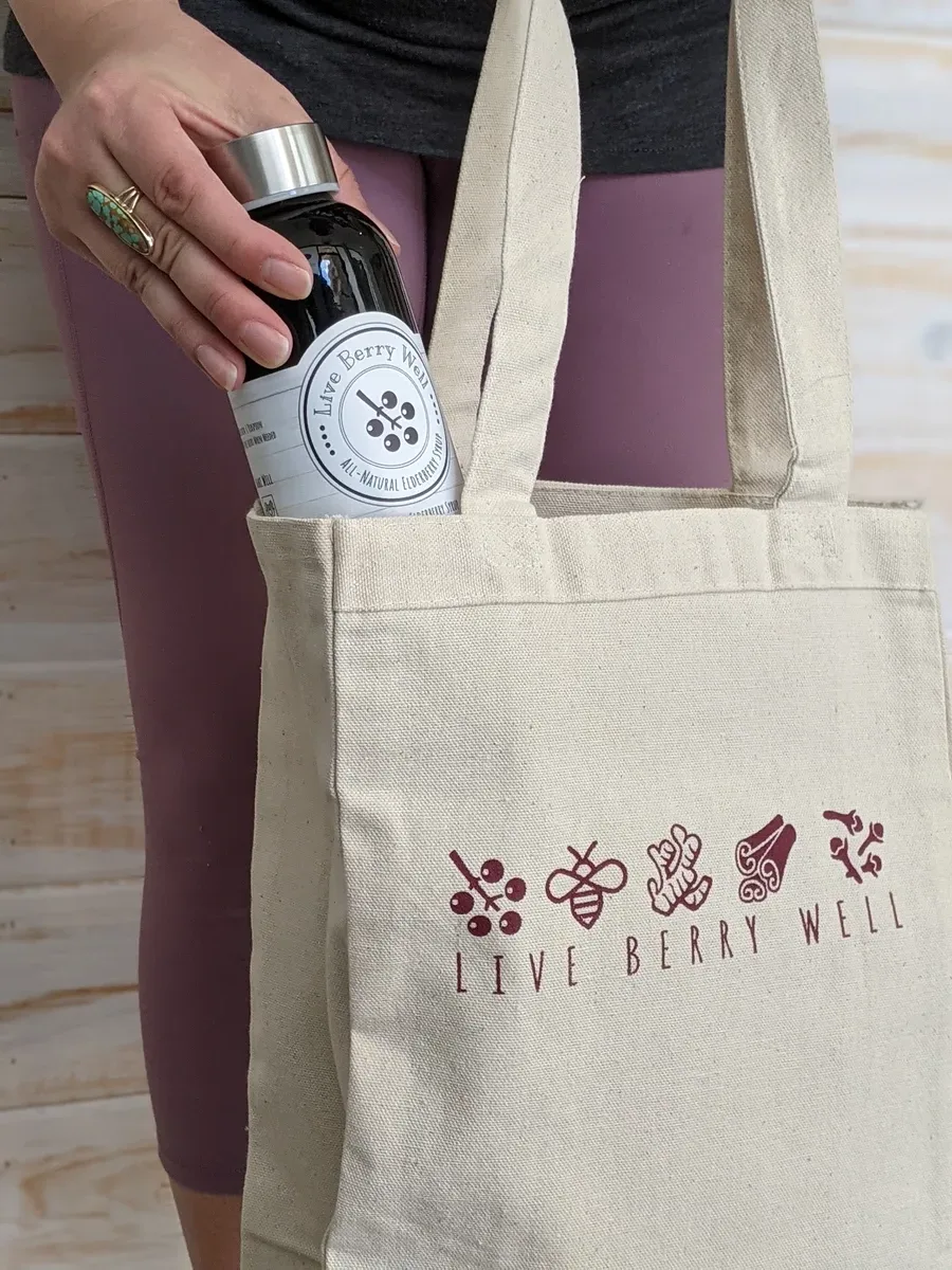 Live Berry Well branded tote bag with syrup